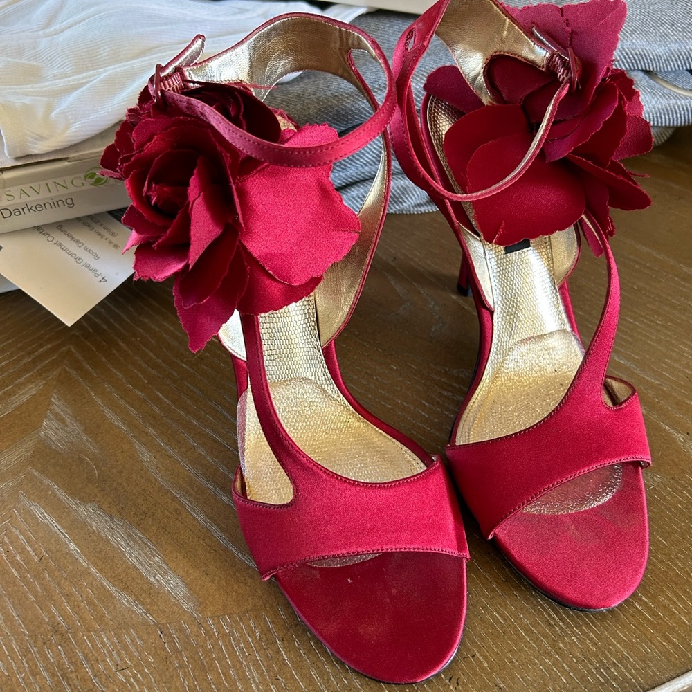Red satin Nina heels with rose embellishment on the side